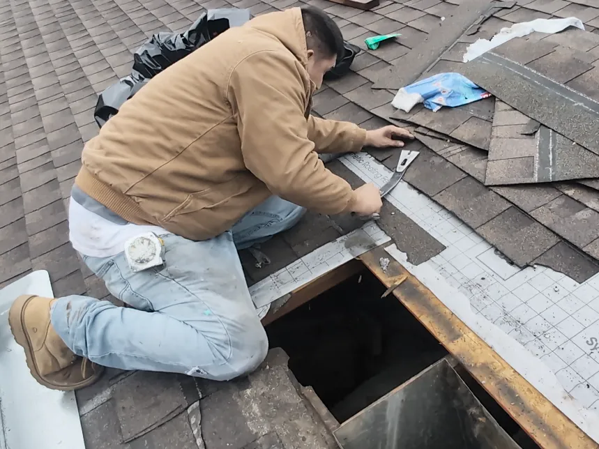 Using a prybar to remove some shingles